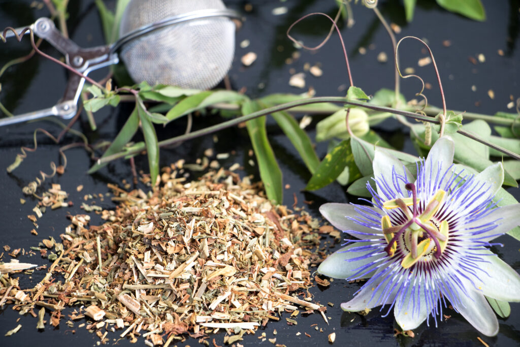 photo showing passion flower and dried cut flowers of passion flower and a tea ball